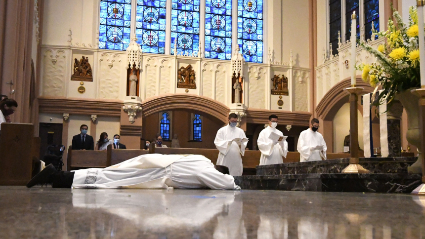Father Jacob McDaniel lies prostrate during his ordination Mass.
