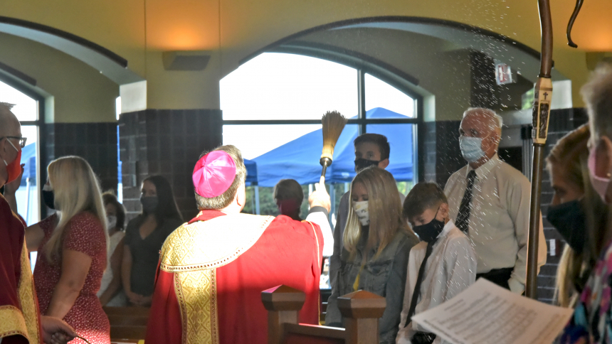 Bishop McClory blesses eighth graders with holy water at Confirmation Aug. 7, 2020