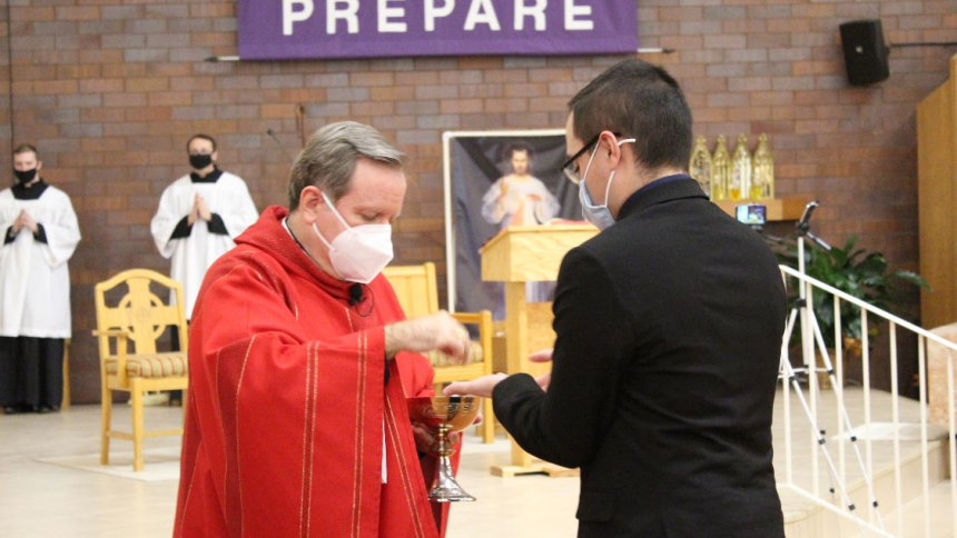 Bishop McClory distributes communion