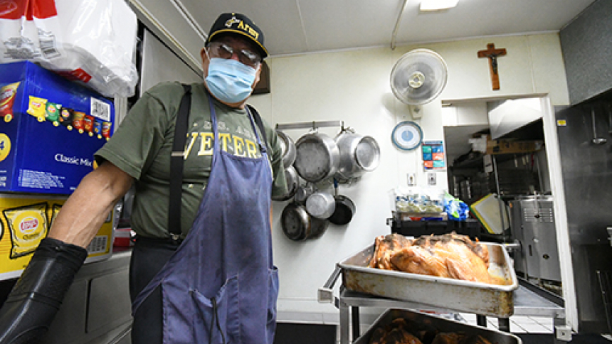 Ray Moreno, coordinator of the St. Joseph Soup Kitchen, moves a cooked turkey for meal preparation in the kitchen at the Manna for Hammond ministry on March 17. 