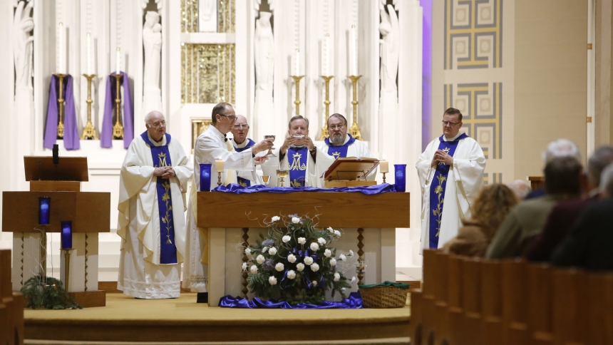 Bishop Robert J. McClory prays the Eucharistic Prayers during the Solemnity of the Immaculate Conception of the Blessed Virgin Mary at St. Mary the Immaculate Conception on Dec. 8. Pictured behind the bishop are as Deacon Michael Green, Father Walter M. Ciesla, Rev. George L. Schopp, Father Walter Rakoczy, and Father David Kime. (Bob Wellinski photo)