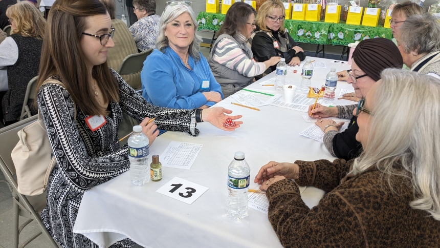 Lesley Erpelding rolls the dice as Vicki Bush looks on during St. Edward's Bunco and Blessings event on Feb. 18. About 100 participants enjoyed food and fellowship in the school gym. (Lynda J. Hemmerling photo)