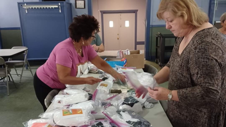 Rose Carrillo and Hope Gonzalez assemble packages for veterans in Northwest Indiana in 2023. The St. John Bosco Altar and Rosary Society members put the care packages together every year in October. (Provided photo)