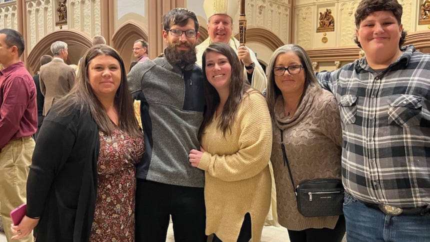 Kristine Horan (second from right) attends Mass with her son, Mark (right), sister and sponsor, Melissa Clancy (left), and brother, Casey Rzechula alongside his fiancé and sponsor, Beverly, at the Cathedra of the Holy Angels for the Rite of Call to Continuing Conversion on Nov. 26, 2023. They are grateful to journey in faith together with Bishop Robert J. McClory behind them. (Provided photo)