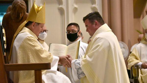 Bishop McClory anoints the hands of Jacob McDaniel at his priestly ordination